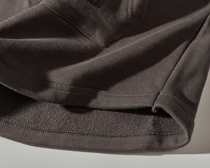 Close-up of warm solid color sweatshirt fabric with cozy interior and precisely stitched hem.